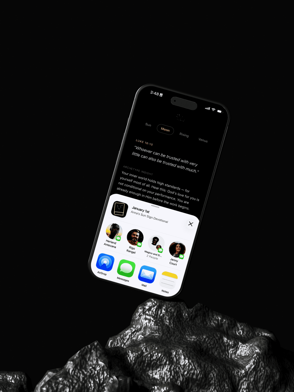 Phone floating above dark rock, displaying an app screen