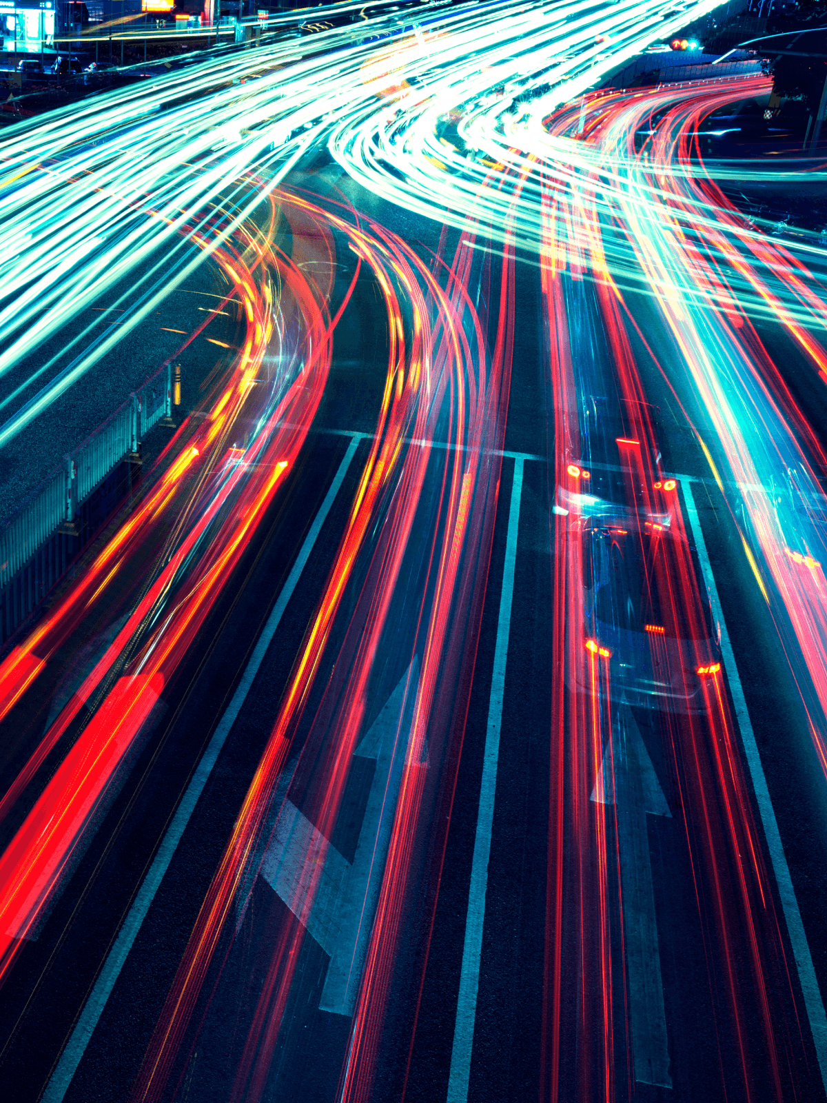 Long-exposure light trails on a highway at night
